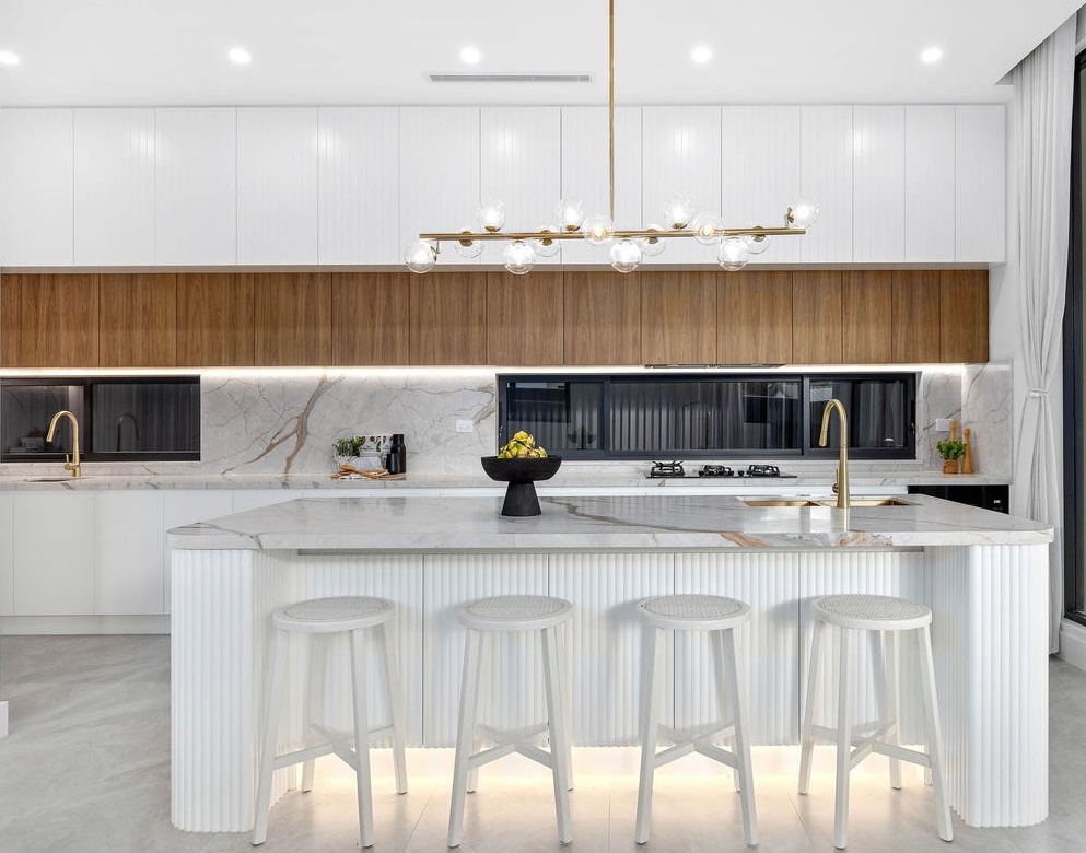 Custom kitchen renovation with a marble waterfall island and timber joinery