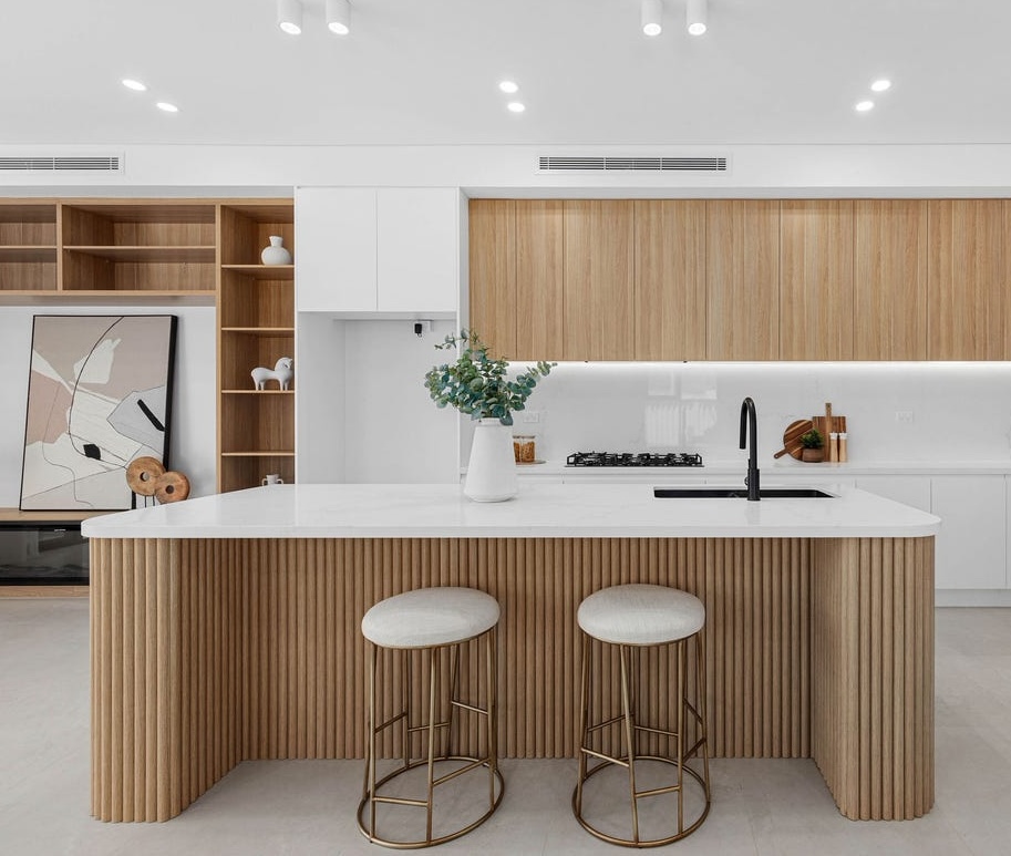 Custom kitchen cabinetry with a fluted timber island